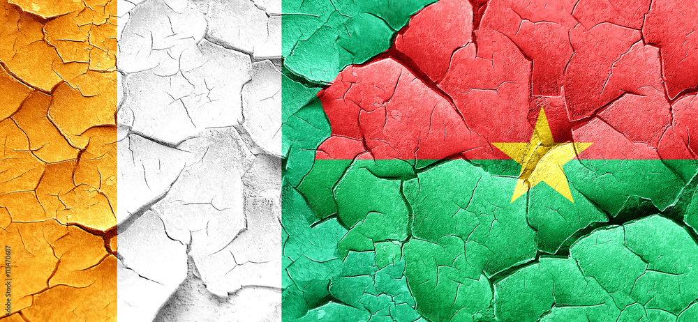 Ivory coast flag with Burkina Faso flag on a grunge cracked wall