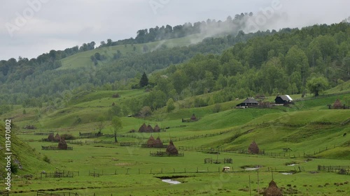 haystacks in foggy mountain