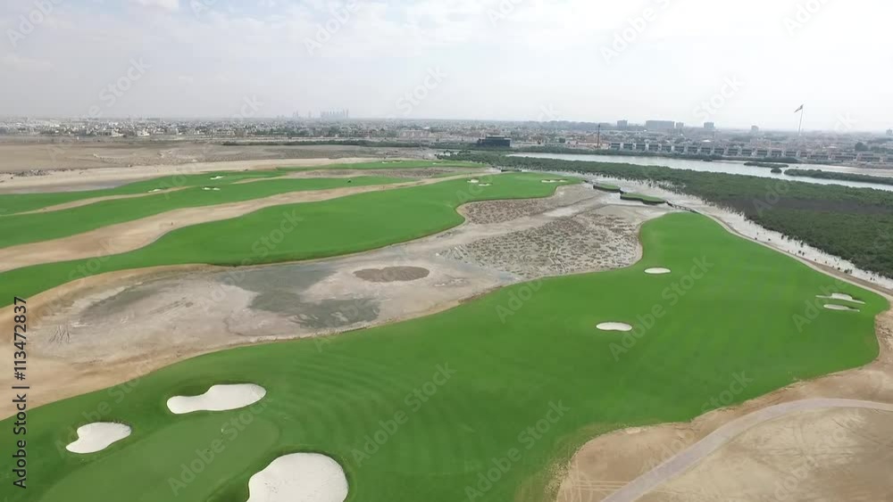 Cityscape of Ajman with golf fields aerial top view Cityscape of Ajman with golf fields aerial top view