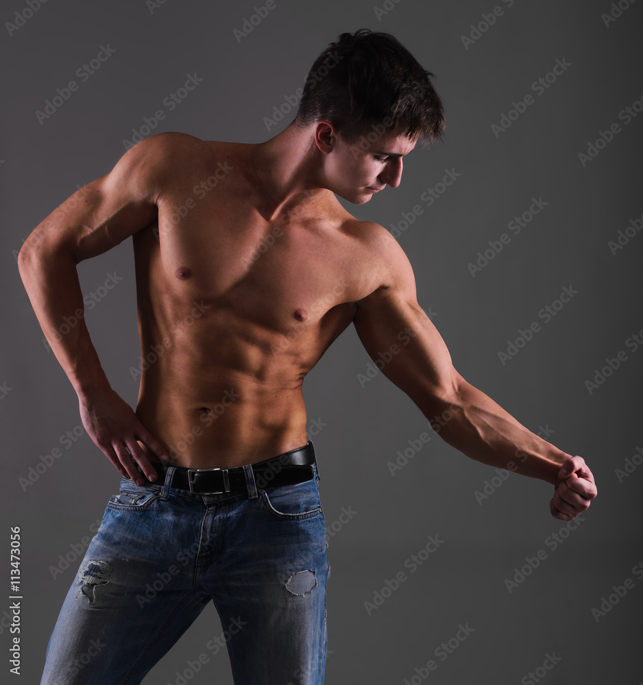 Shirtless muscular guy from back in blue jeans Stock Photo | Adobe Stock