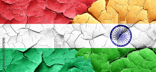 Hungary flag with India flag on a grunge cracked wall
