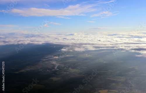 view of the clouds from an airplane window. © wolfness72