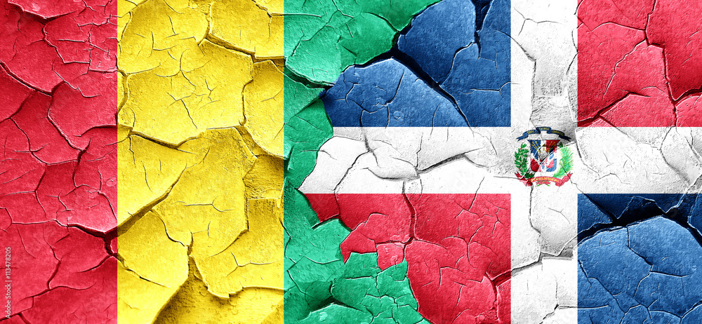 Guinea flag with Dominican Republic flag on a grunge cracked wal