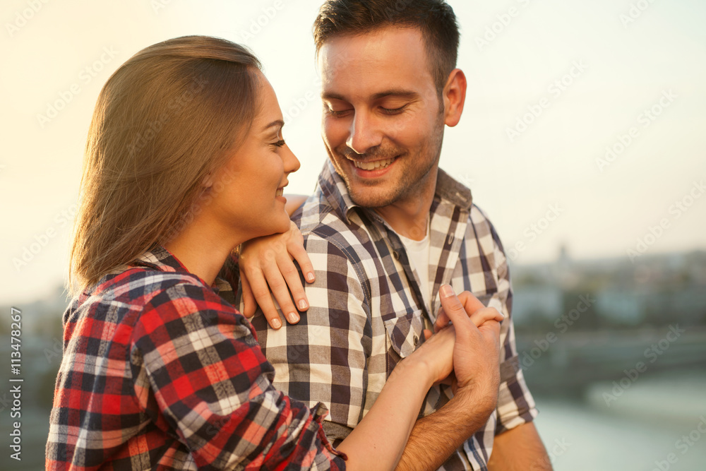 young couple in sunset loving each other, outdoors young couple in sunset loving each other, outdoors