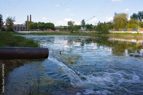 sewage from the sewer pollute a lake, river photo