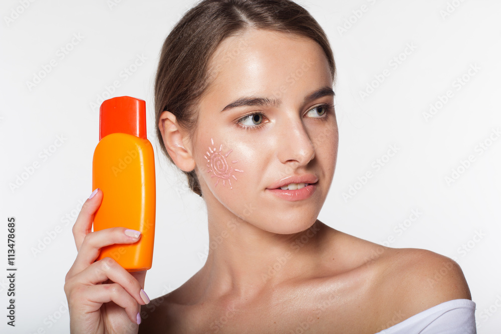 Pretty girl with jar of sunscreen lotion Pretty girl with jar of sunscreen lotion