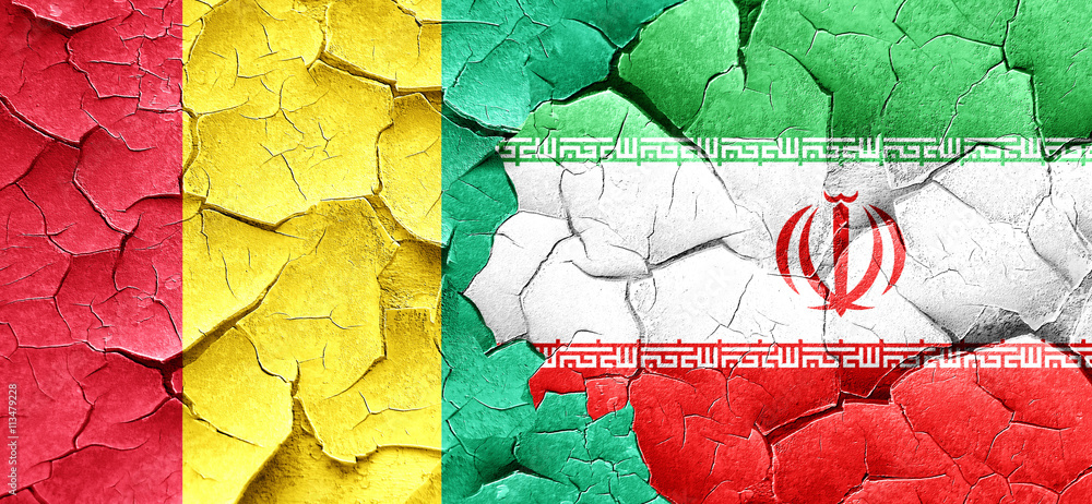 Guinea flag with Iran flag on a grunge cracked wall