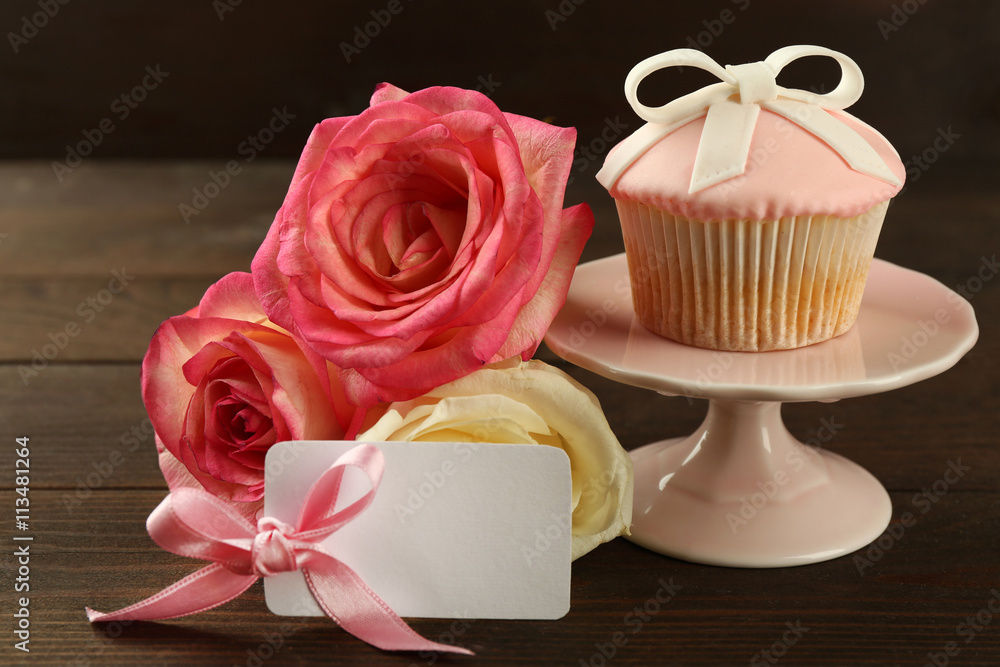 Happy Mother's day concept. Roses and cupcake on wooden background Happy Mother's day concept. Roses and cupcake on wooden background
