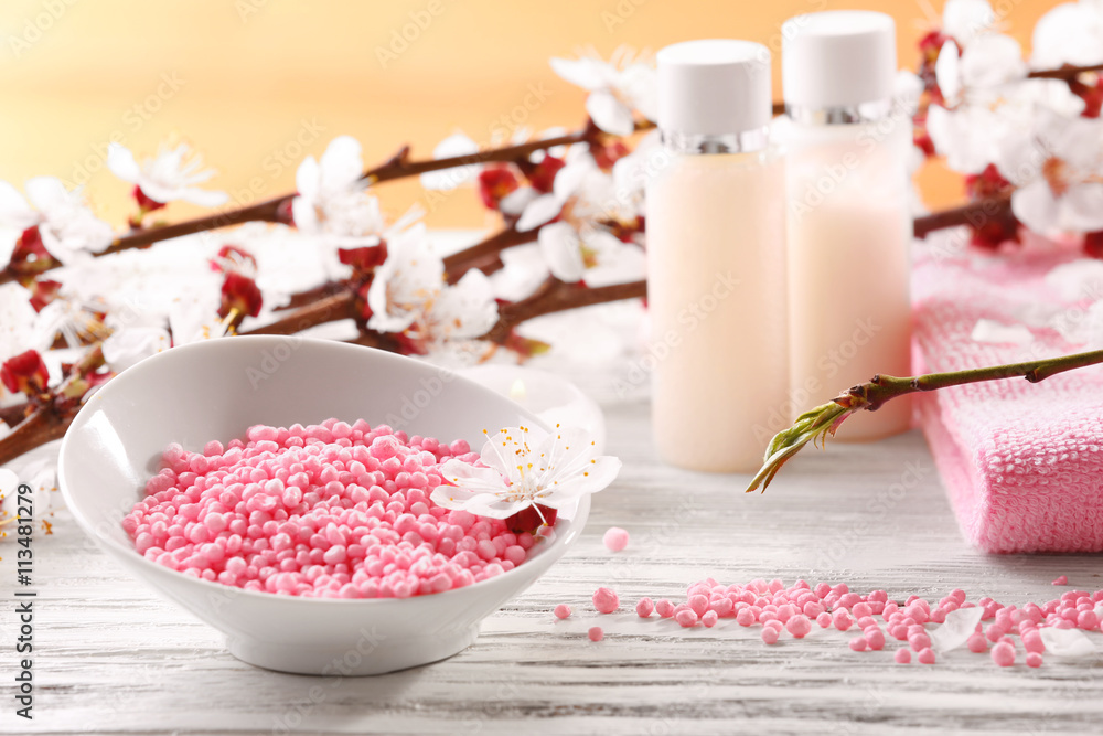 Spa composition with blooming branches on wooden table Spa composition with blooming branches on wooden table