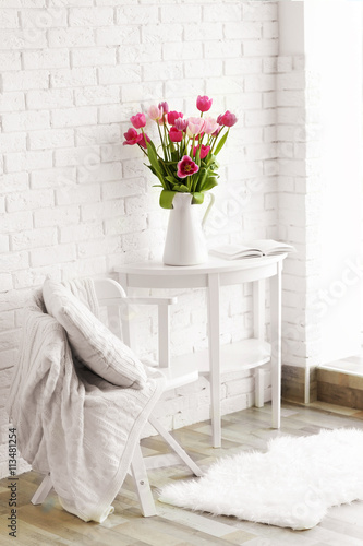 Beautiful tulips on white wooden table