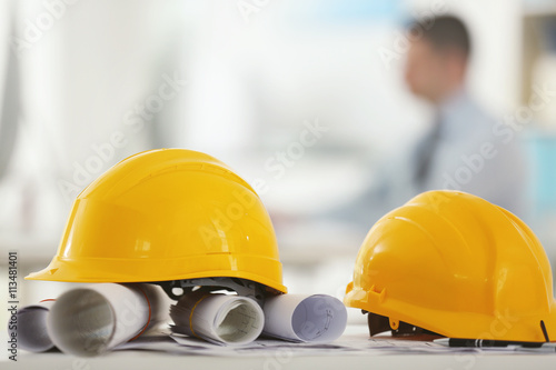 Yellow helmets on office ta...