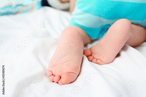 Baby feet on bed, closeup