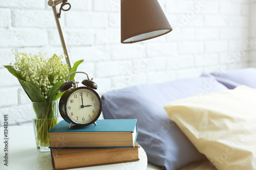 Lamp, books and alarm clock...