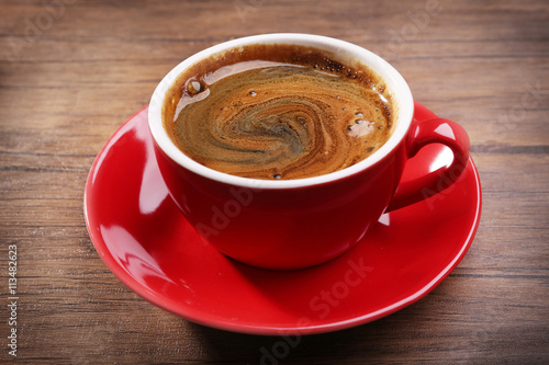 Cup of fresh coffee on wooden background