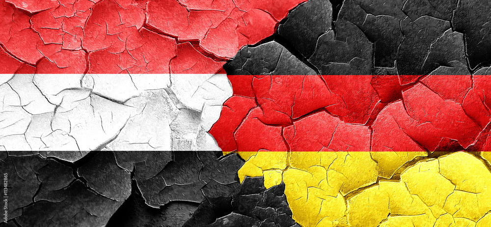 Yemen flag with Germany flag on a grunge cracked wall