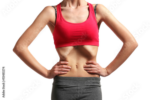 Belly of young woman with anorexia on white background © Africa Studio