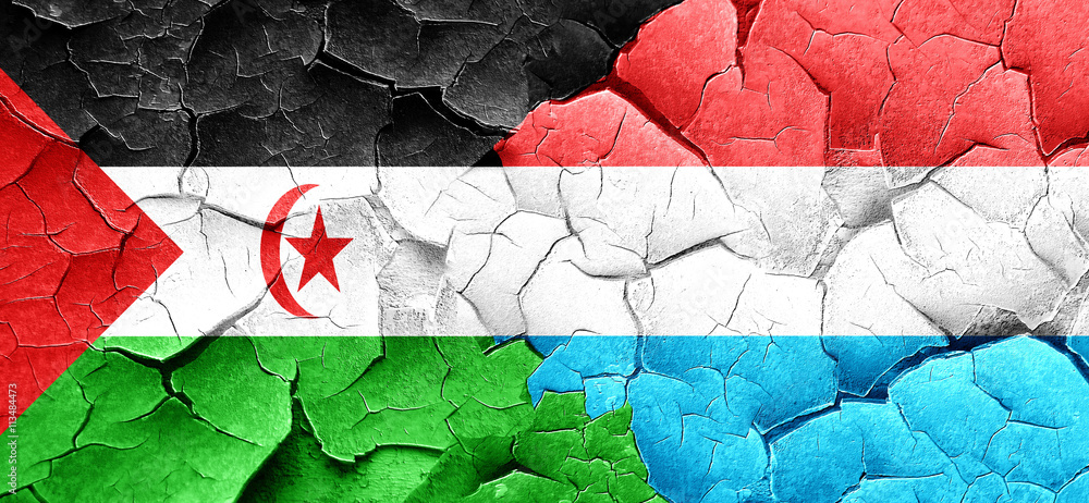 Western sahara flag with Luxembourg flag on a grunge cracked wal
