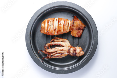 Grilled squid on frying pan over white background