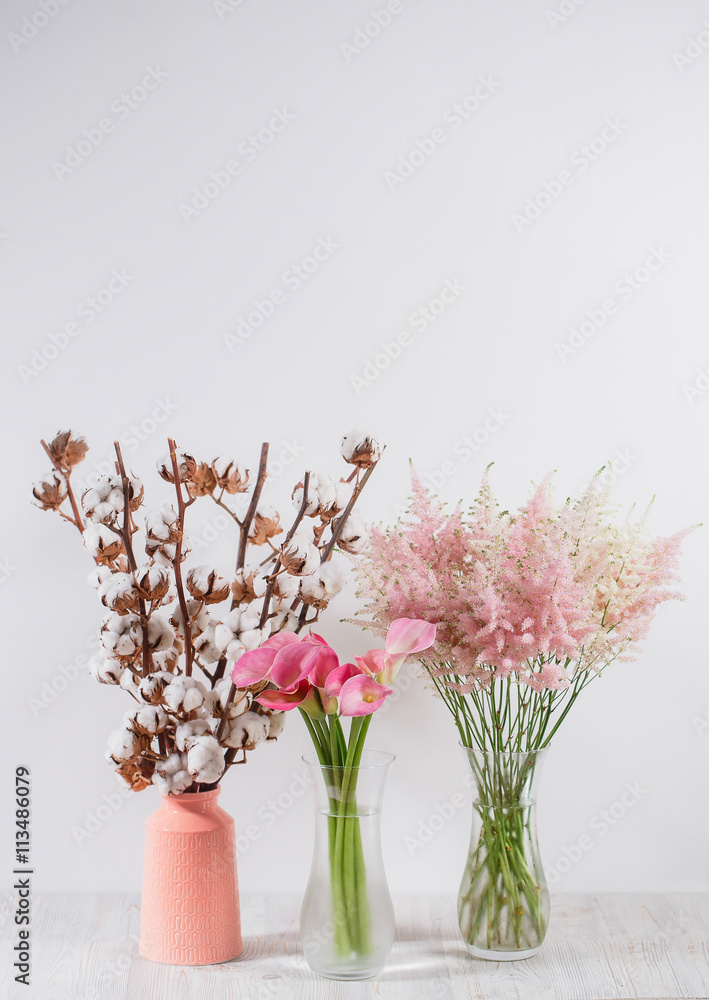 cotton flowers in a vase on  wooden background