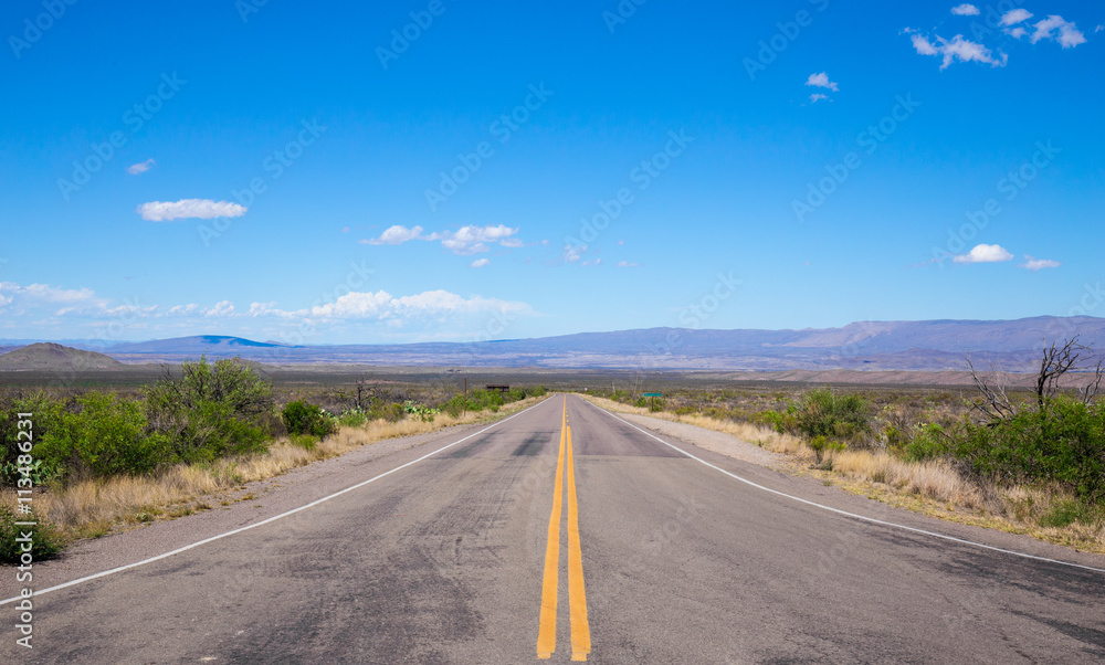 Beautiful cinematic view of the road under the blue cloudless sky in America Beautiful cinematic view of the road under the blue cloudless sky in America