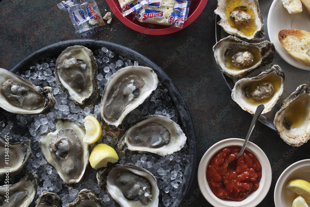 Overhead view of oysters served with sauce on table Overhead view of oysters served with sauce on table