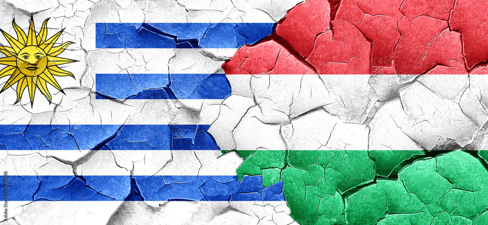 Uruguay flag with Hungary flag on a grunge cracked wall