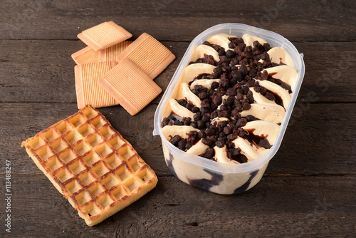 Pan with vanilla ice cream chocolate sprinkles and waffle iron photo