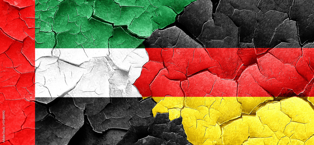 uae flag with Germany flag on a grunge cracked wall