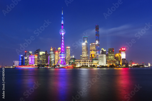 Scenic view of river and illuminated cityscape against sky photo