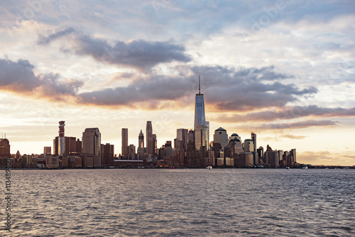 Capital city and sea against sky during sunset