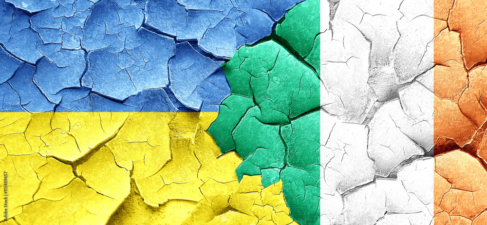 Ukraine flag with Ireland flag on a grunge cracked wall Ukraine flag with Ireland flag on a grunge cracked wall