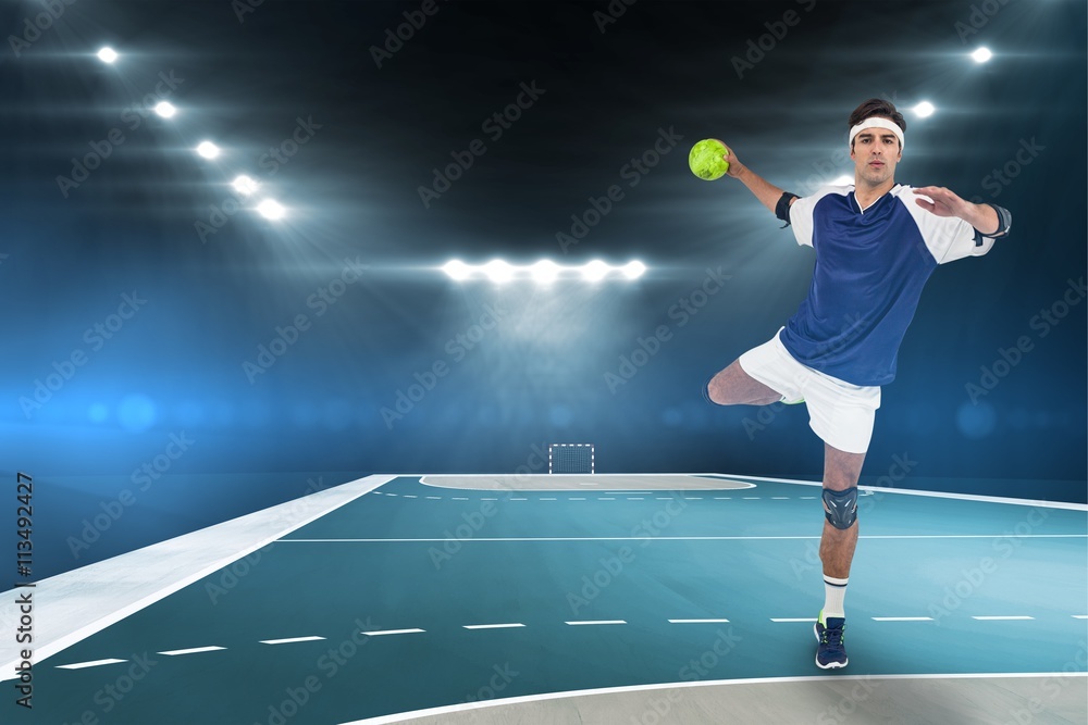 Portrait of sportsman throwing a ball against handball field indoor Portrait of sportsman throwing a ball against handball field indoor