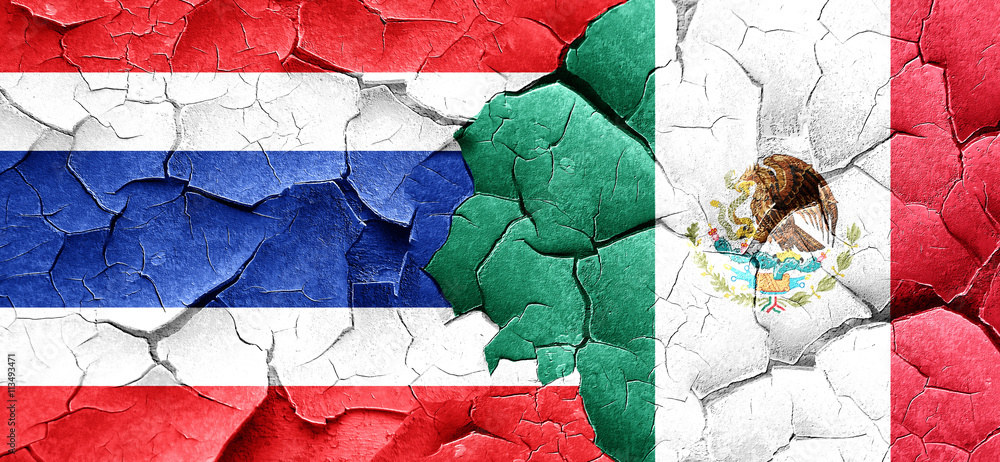 Thailand flag with Mexico flag on a grunge cracked wall