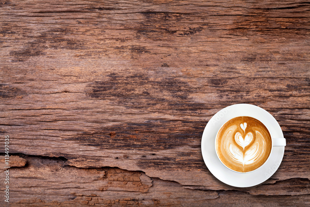 Top view latte art coffee on wood texture background