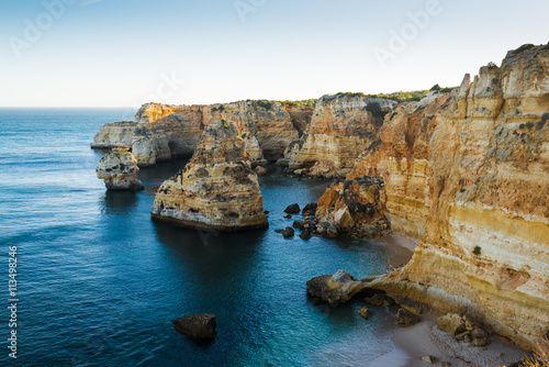 Lovely evening with a view of the ocean and cliffs. Praia da Marina. Region Algarve. Portugal
