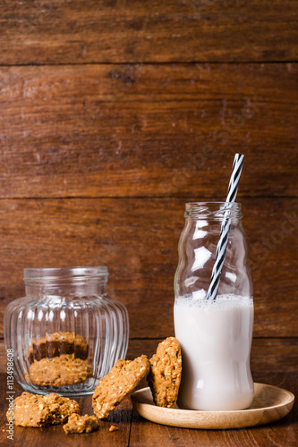 Stack of whole grains cookies with milk bottle