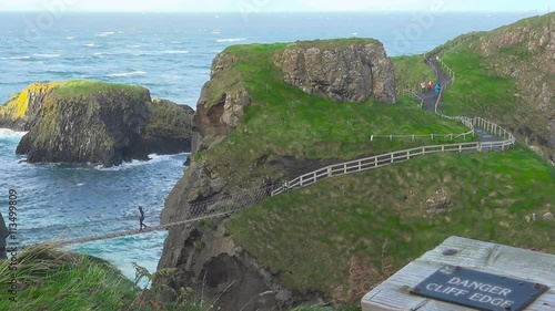 People walking on Carrick-a-Rede Rope Bridge, Ballintoy, Northern Ireland, UK, November 2015
