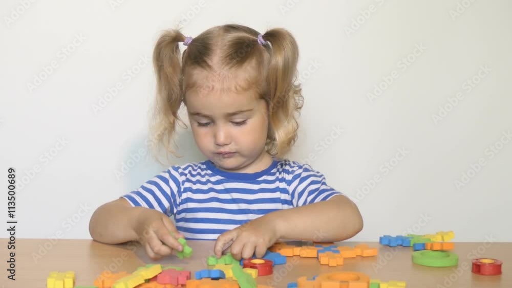 child little girl playing plastic toys at home or kindergarten.children designer. child little girl playing plastic toys at home or kindergarten.children designer.