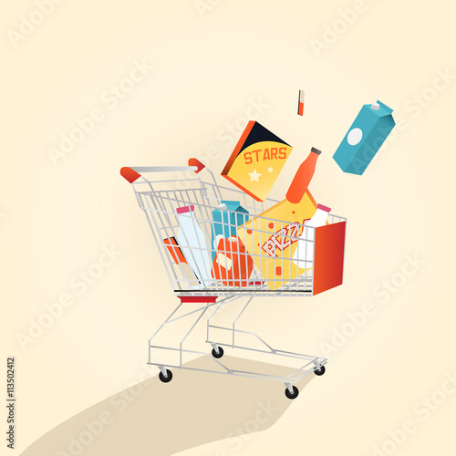 Supermarket shopping cart full with various freshgrocery products.