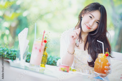 Pretty girl is enjoy with dessert and drinks photo