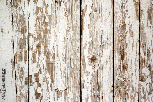 White paint peeling off the wooden wall