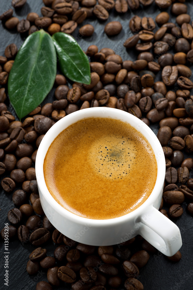 cup of fresh espresso on coffee beans background, top view cup of fresh espresso on coffee beans background, top view