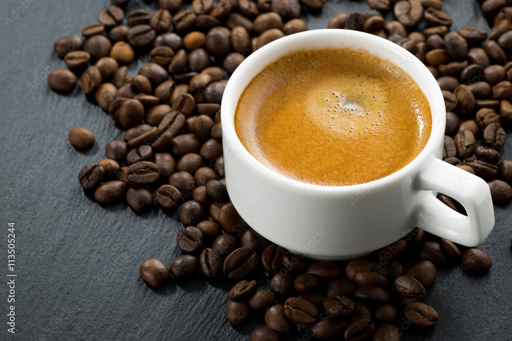 espresso on coffee beans background espresso on coffee beans background