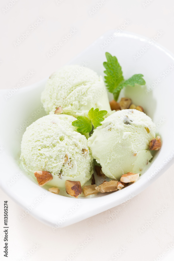pistachio ice cream in a bowl, vertical, closeup pistachio ice cream in a bowl, vertical, closeup