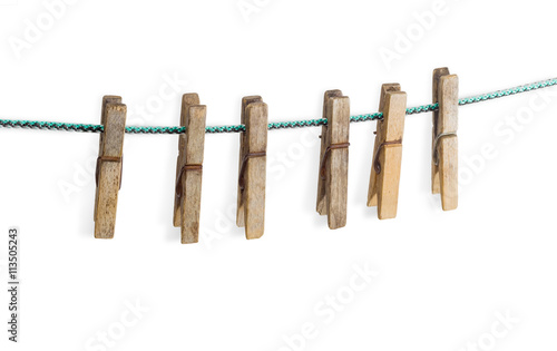 Old spring type wooden clothespin on a light background