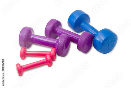 Several dumbbell different colors, weight and sizes on light bac