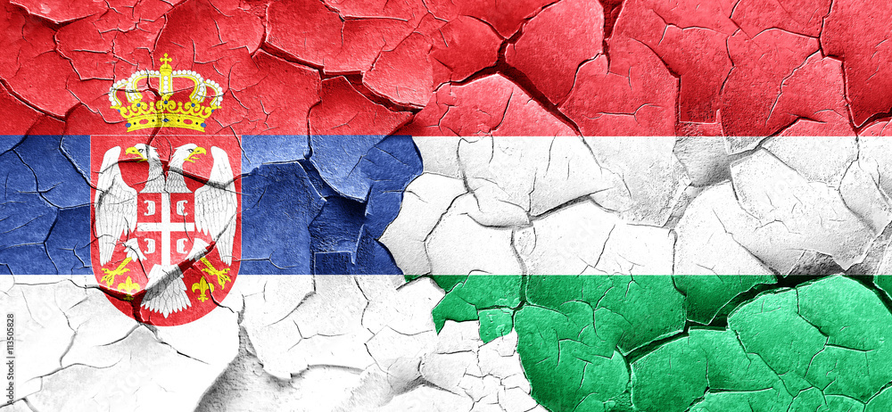 Serbia flag with Hungary flag on a grunge cracked wall