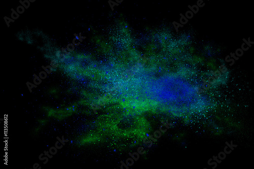 Cyan abstract powder explosion on a black background