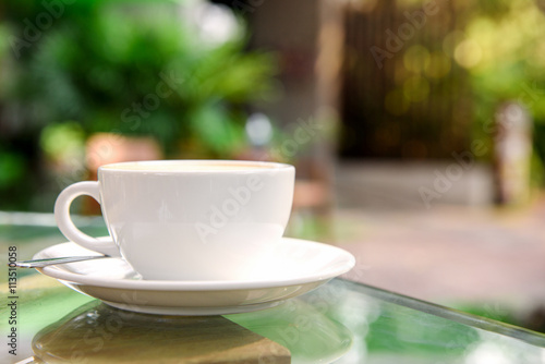 Cup of coffee with green nature background