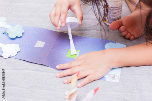 Little girl is cutting the paper
